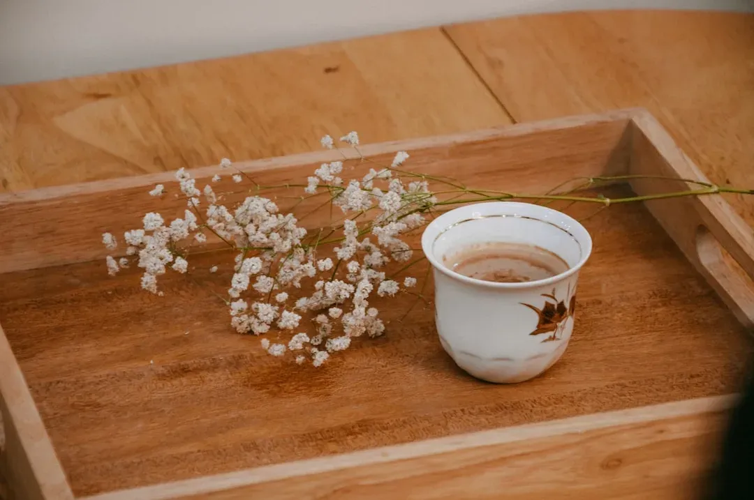 a selection of coffee cups on a decorative tray in a cozy coffeehouse setting